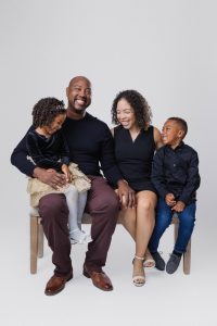 Family of four laughing together during an in-studio family photography session in Monrovia, California