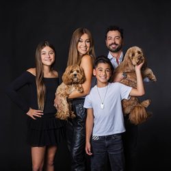 family-dog-studio-photography-monrovia Family of four with their two dogs posing for a modern studio family portrait on a black backdrop in Monrovia, California
